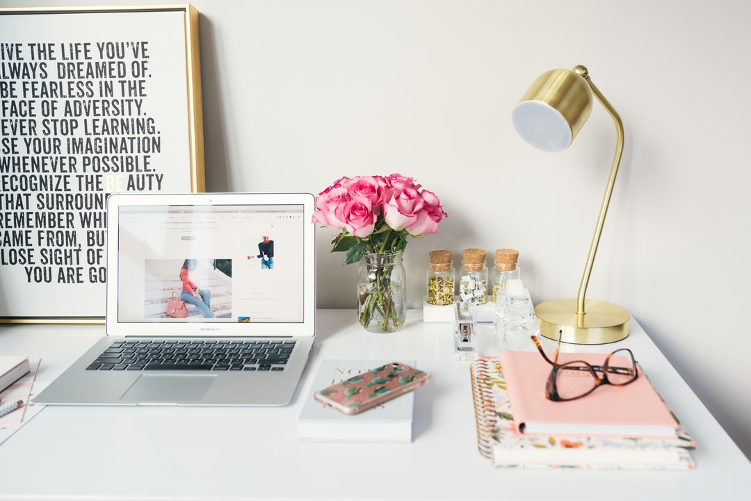 desk with computer and lamp