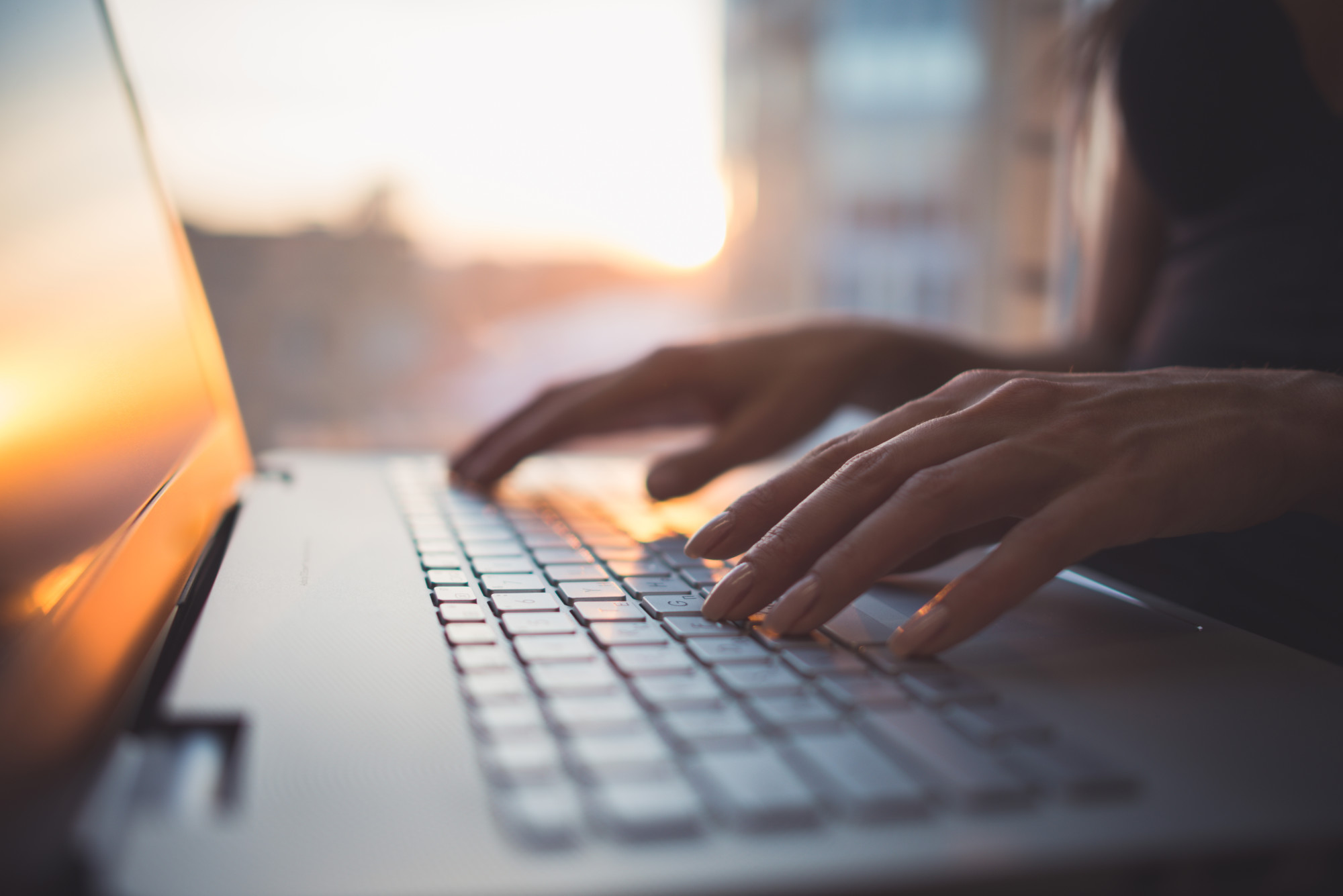 Blogger Typing on a Laptop